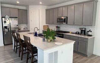 renovated kitchen with gray cabinets- colored kitchen cabinets