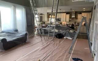 interior paint set up with tarps and ladders