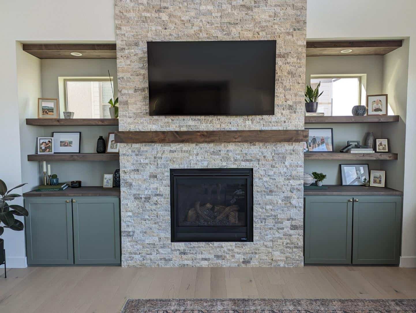 custom built-ins and shelving surrounding a brick fireplace