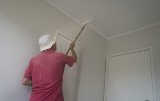 man painting ceilings without streaks